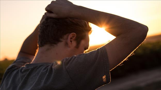 Man holding head in hands